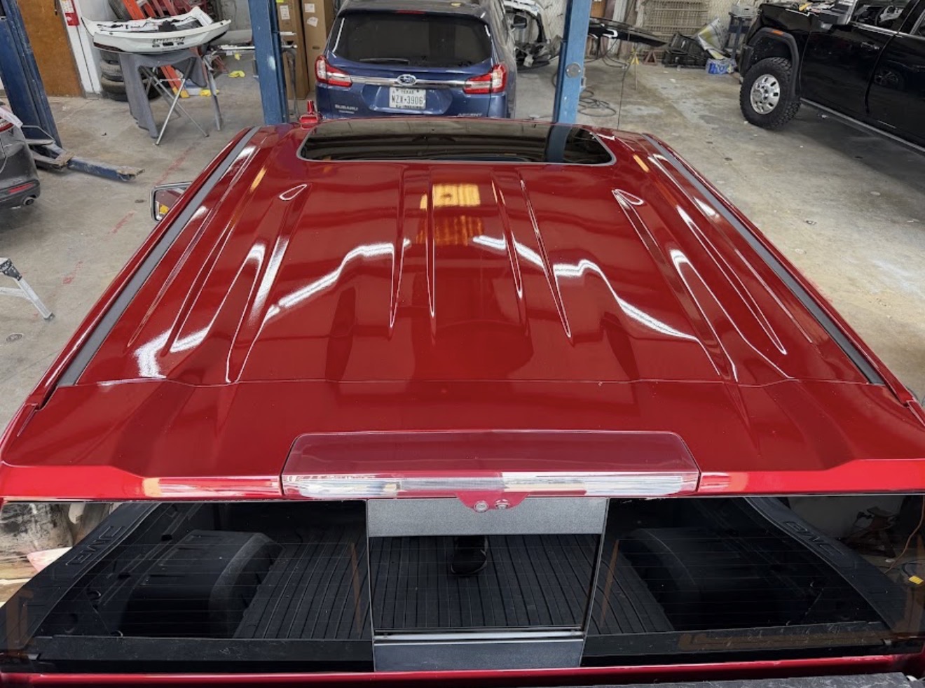 Pickup truck roof after paintless dent repair by DG Collision Center Lewisville TX — hail dents fully removed, factory paint preserved