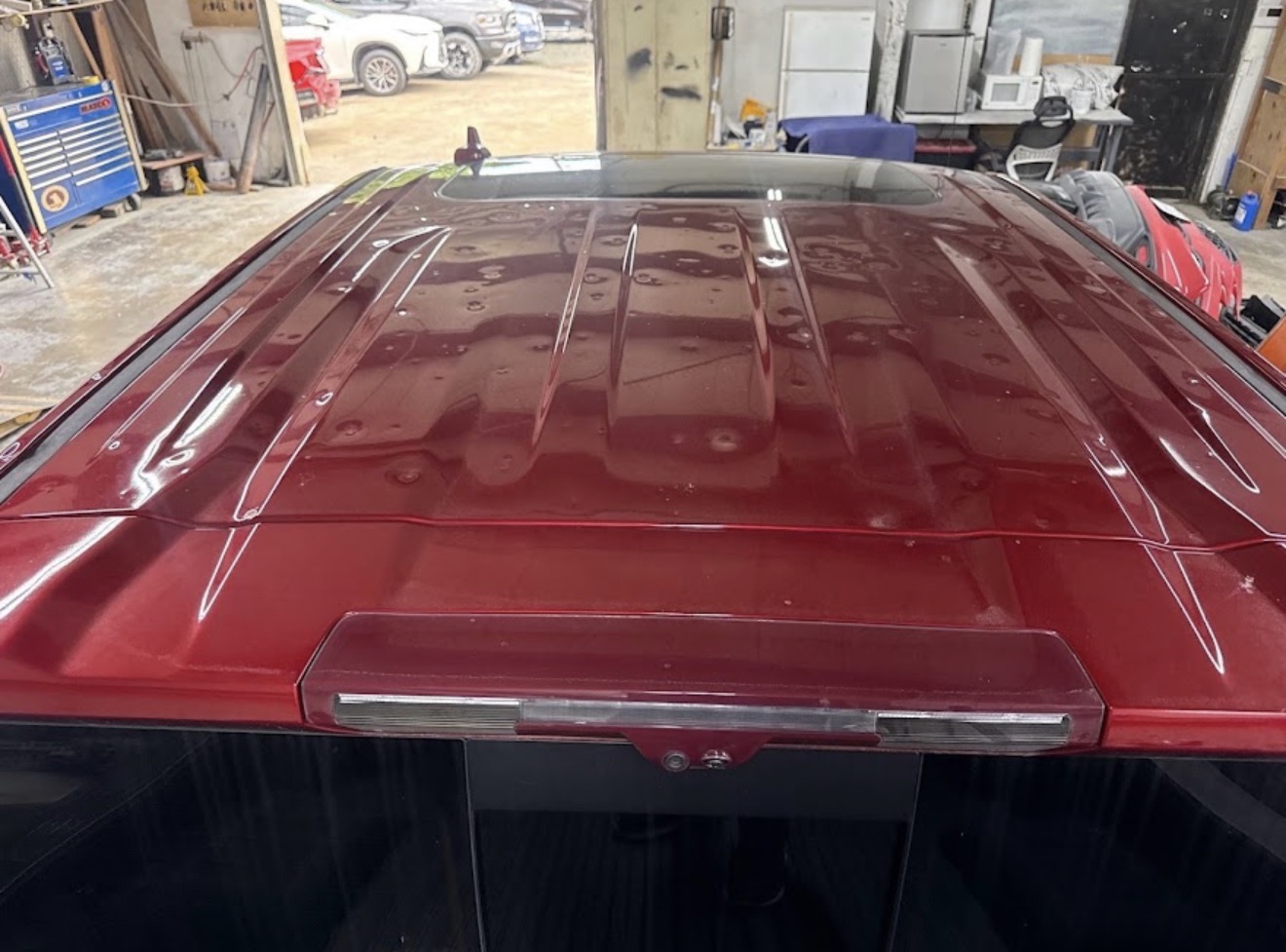 Pickup truck roof covered in hail dents before paintless dent repair at DG Collision Center