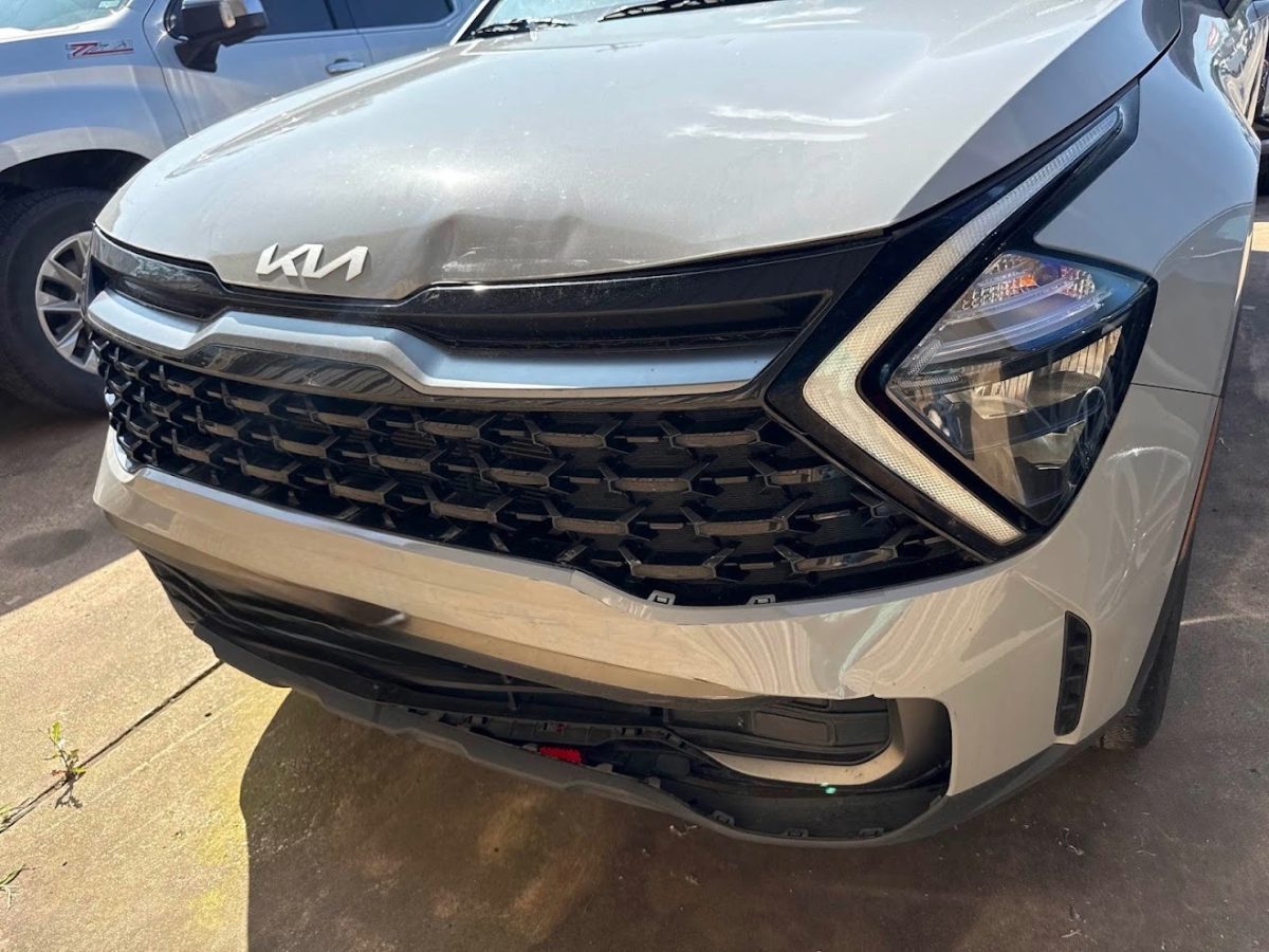 Kia Sportage with front bumper and hood damage before repair at DG Collision Center Lewisville TX