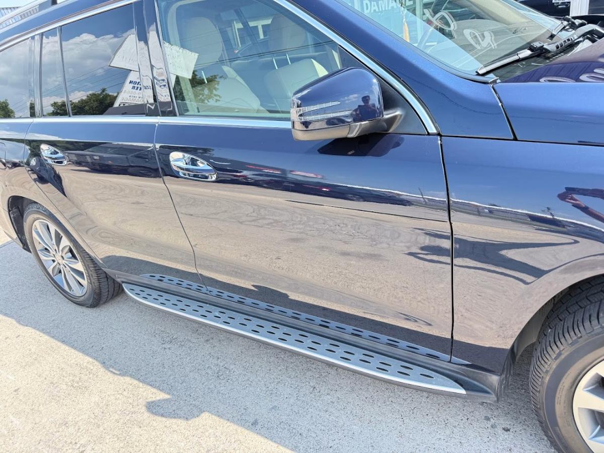 Customer's Mercedes-Benz GLS with doors fully repaired and refinished at DG Collision Center Lewisville TX &mdash; read in reflection before delivery