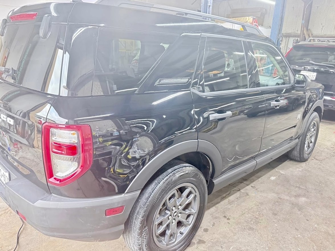 Side-impact collision repair for a Highland Village TX customer — door panel replaced and color-matched at DG Collision Center